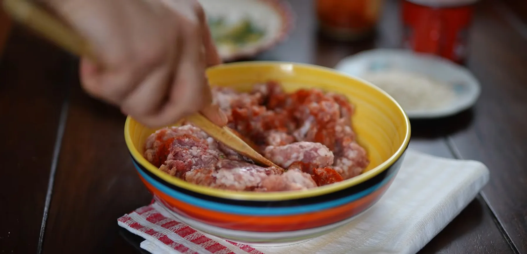 Umplutură de carne tocată amestecată cu lingura într-un bol colorat